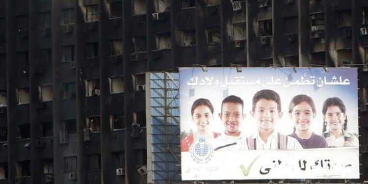 A National Democratic Party (NDP) sign is seen in front of their burned headquarters in downtown Cairo January 31, 2011. Protesters intensified their campaign on Monday to force Egypt's President Hosni Mubarak to quit as world leaders struggled to find a solution to a crisis that has torn up the Middle East political map. The sign reads "in order to be confident about the future of your children". REUTERS/Amr Abdallah Dalsh  (EGYPT - Tags: POLITICS CIVIL UNREST) - RTXXBNJ